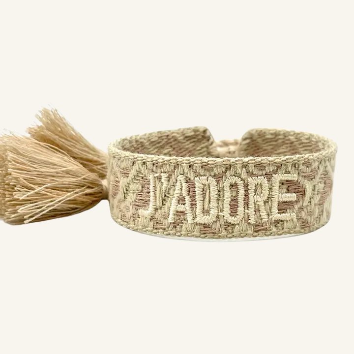 Bracciale in tessuto ricamato oro con scritta "J'ADORE"